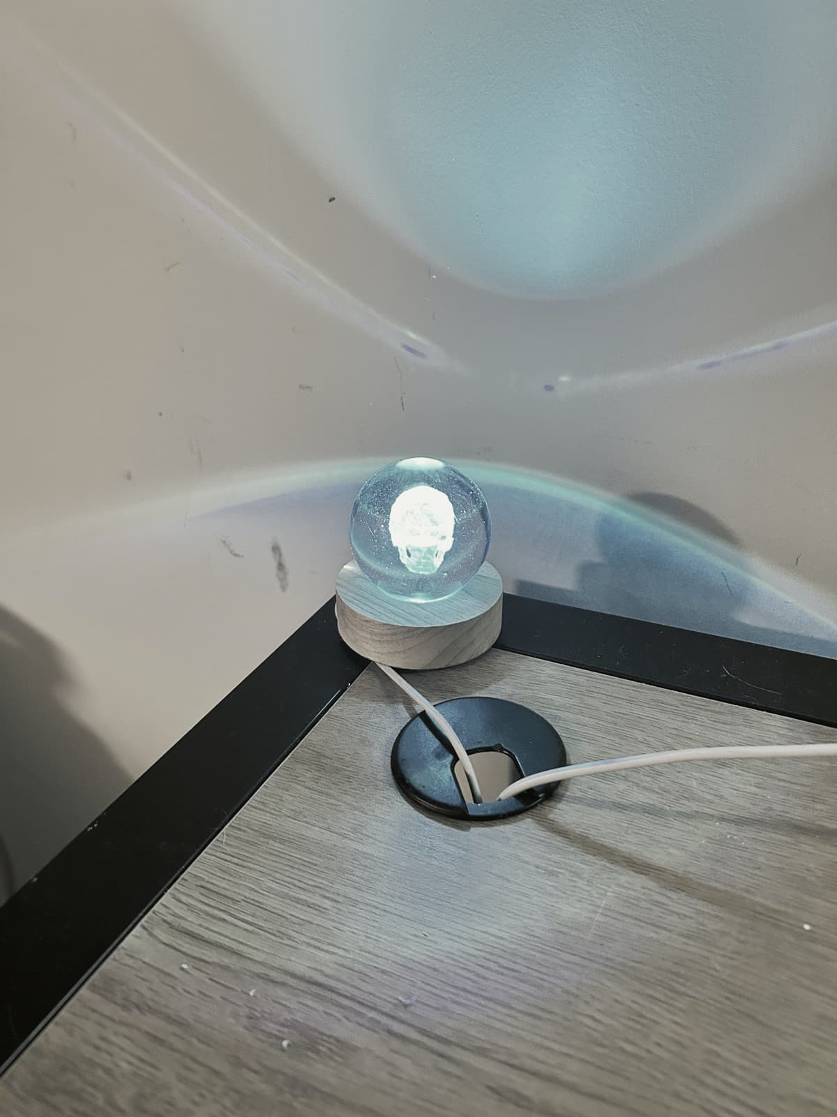 A blue crystal lamp throwing light onto the wall
